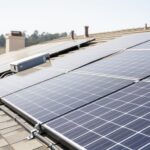 “Rooftop solar panels on a California home under a bright overcast sky, with blurred neighborhood background.”